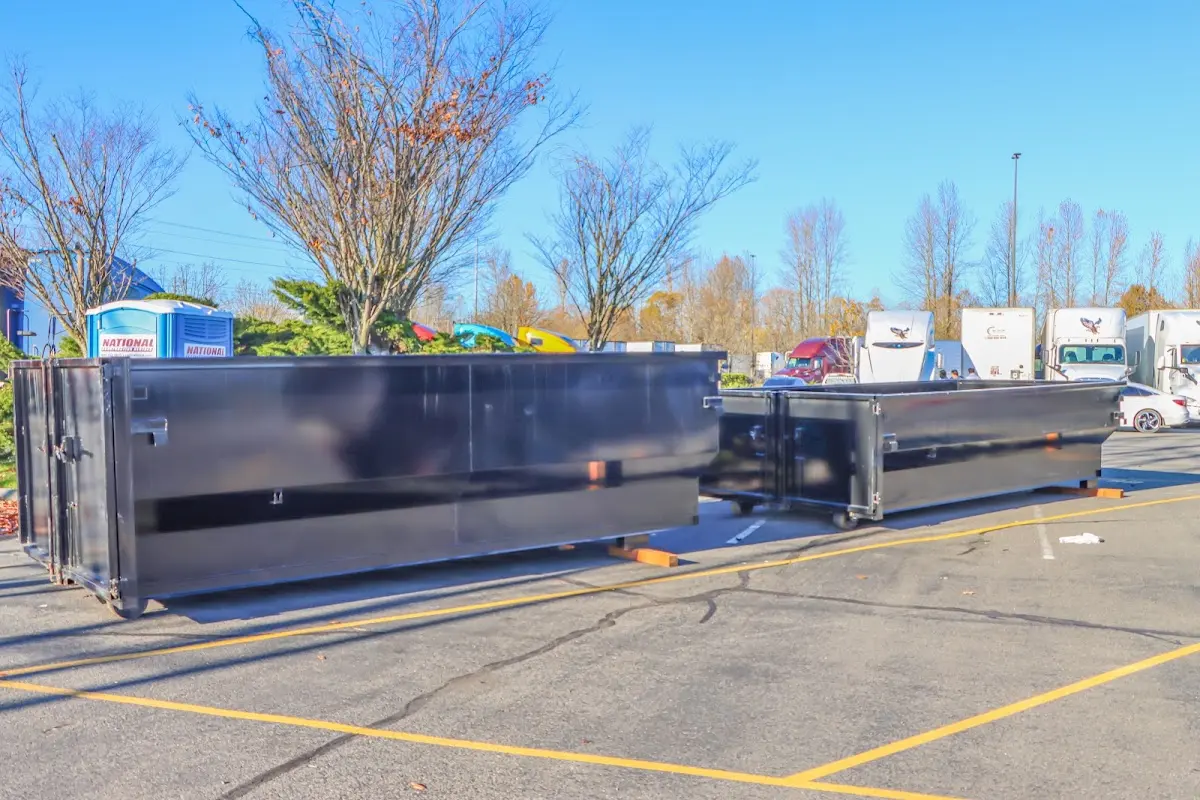 Professional dumpster rental service with roll-off container on residential driveway in Hugo